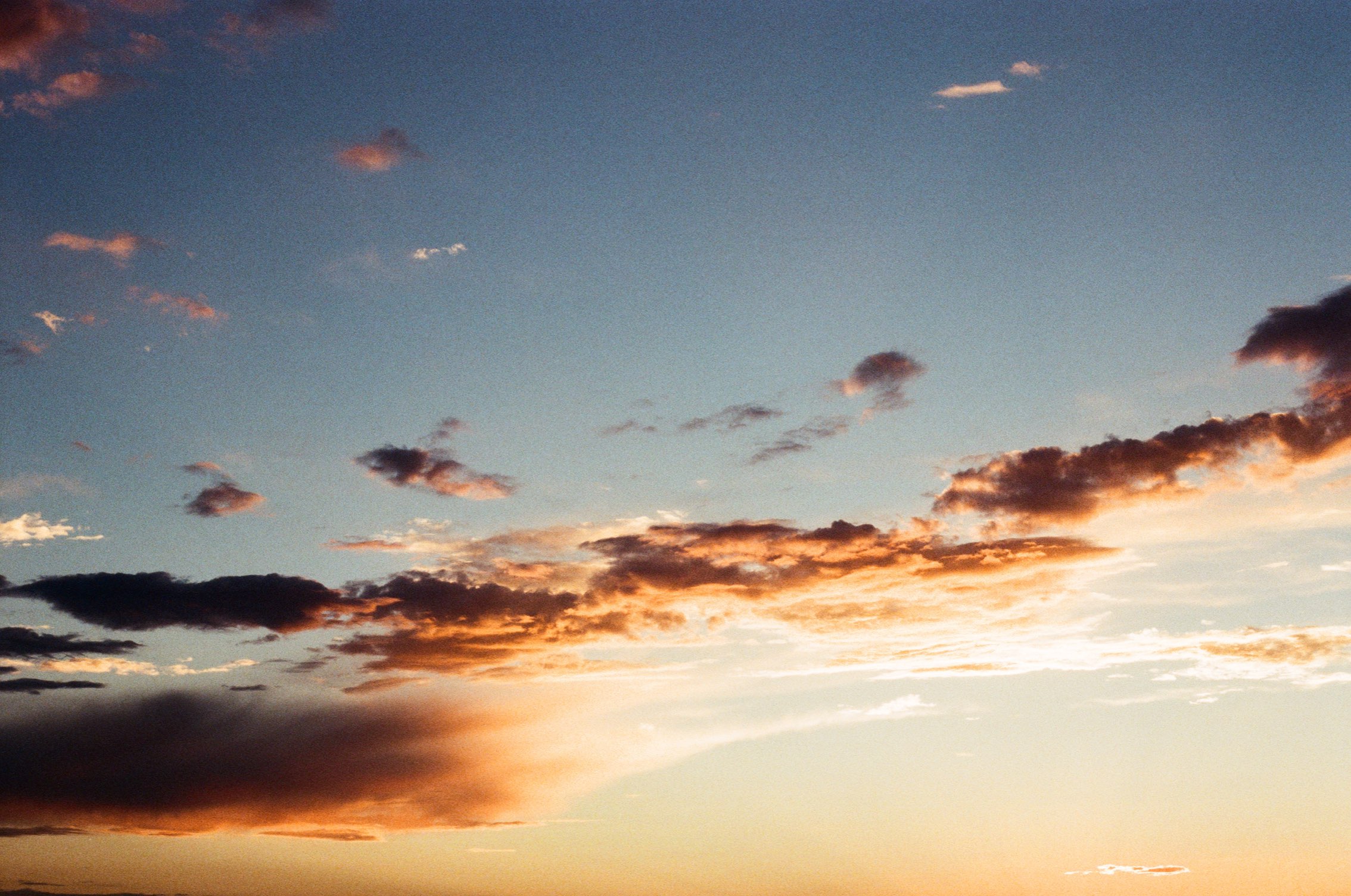 Scattered clouds lit orange at sunset