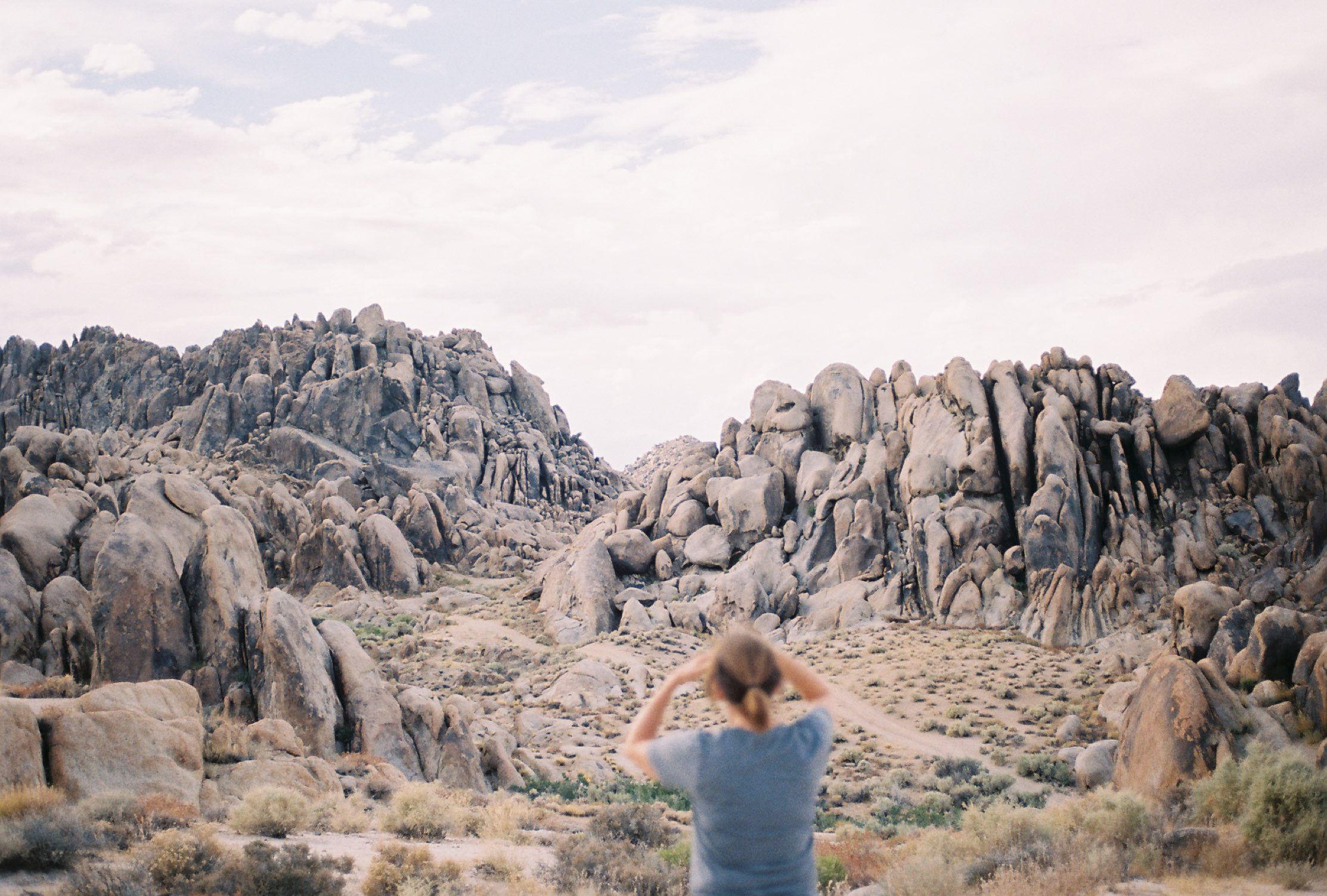 A person standing among giant granite boulders