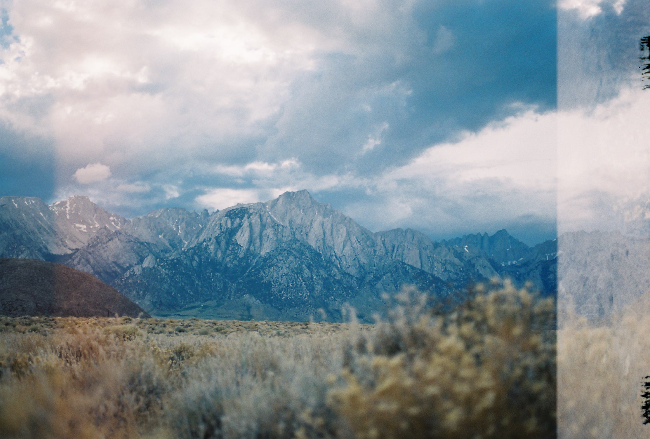 Mountains under billowing clouds beyond sagebrush